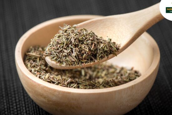 A wooden spoon overflowing with a variety of dried herbs, showcasing their rich textures and earthy colors.